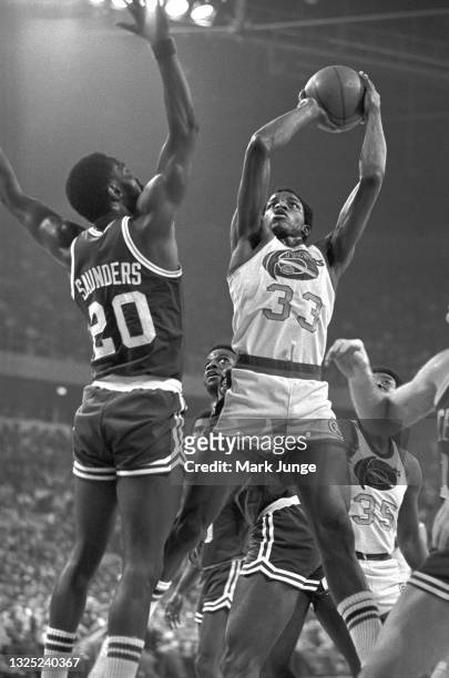 Denver Nuggets forward David Thompson leaps under the basket for a jump shot during a game against the Boston Celtics at McNichols Arena on February...