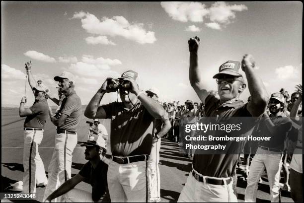 View of race team members cheer during the National Championship Air Races at the Reno Stead Airport, Reno, Nevada, September 10-16, 1984.