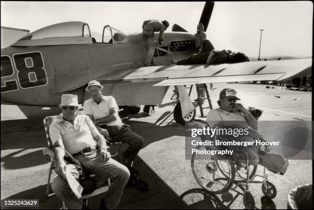 View of a group of spectators, next to and on a plane, during the National Championship Air Races at the Reno Stead Airport, Reno, Nevada, September...