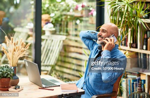 cheerful businessman talking on mobile phone at home - call ストックフォトと画像