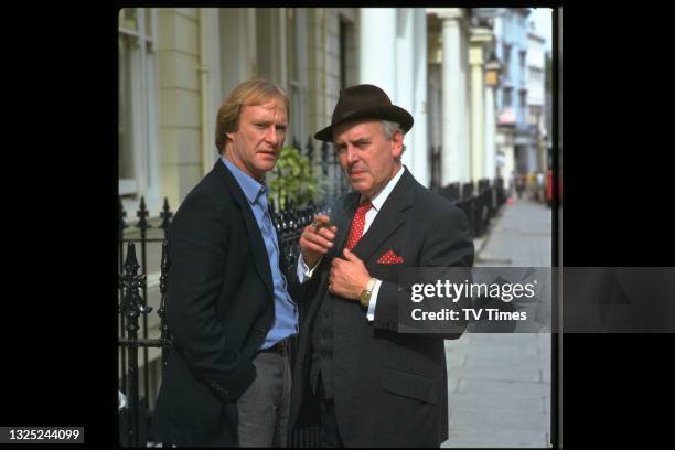 Actors George Cole and Dennis Waterman in character as Arthur Daley and Terry McCann on the set of comedy drama series Minder, circa 1984.