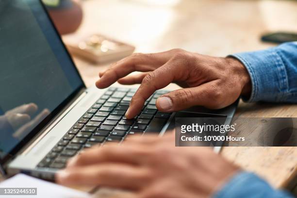 mature man using laptop keyboard close up - touchpad stock-fotos und bilder