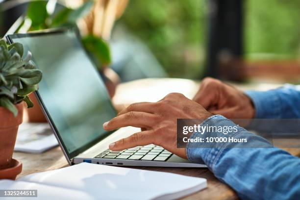 close up of man's hands typing on laptop keyboard - hands laptop stock pictures, royalty-free photos & images