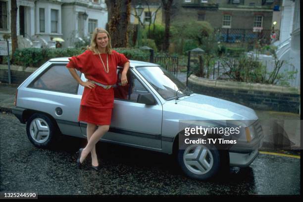 Television presenter Anneka Rice, known for her role in the game show Treasure Hunt, posed with her car, circa 1984.
