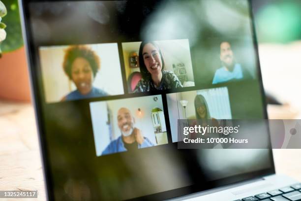 smiling faces on laptop screen during video call - meeting community fotografías e imágenes de stock