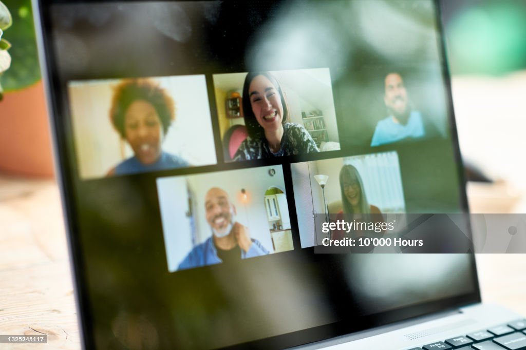 Smiling faces on laptop screen during video call