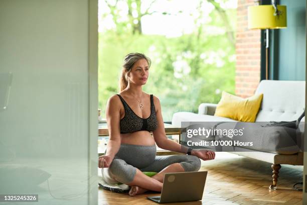 pregnant woman doing breathing exercises during on line class - prenatal class stock-fotos und bilder