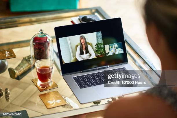 pregnant mature woman talking with doula on video call - virtual coach stock pictures, royalty-free photos & images