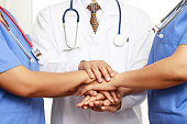 Concept Teamwork doctor and nurses coordinate hands for success work