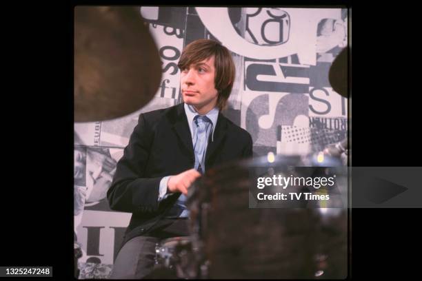 Drummer Charlie Watts of rock & roll group The Rolling Stones performing on music programme Ready Steady Go! in London, circa 1964.