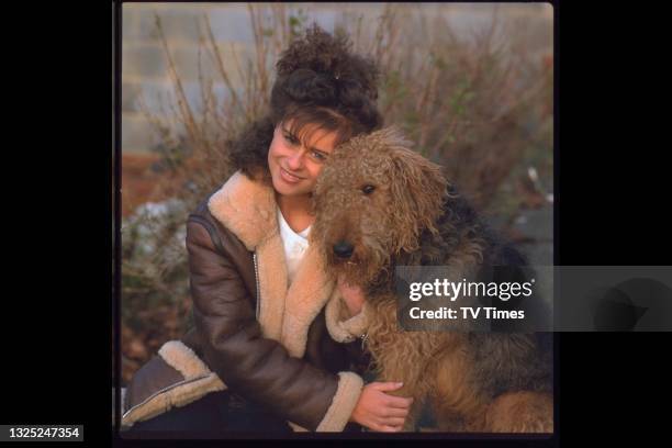 English pop singer Lisa Stansfield photographed at home with her dog, circa 1983.