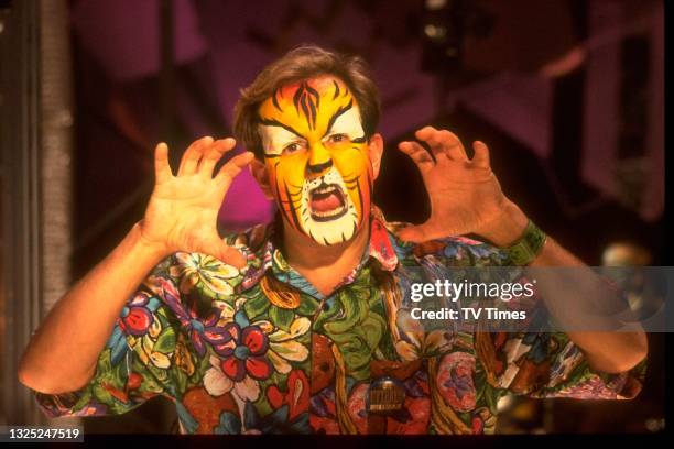 Children's television presenter Timmy Mallett wearing tiger face paint, circa 1989.