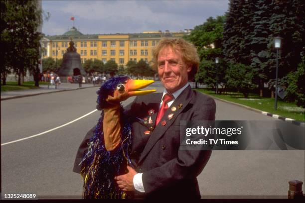 Entertainer Rod Hull photographed with his puppet Emu in front of the Kremlin Senate in Moscow, Soviet Union, circa 1989. .