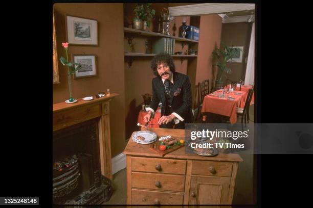 Actor Peter Wyngarde, known for his role as Jason King in spy adventure series Department S, photographed serving a meal at home, circa 1972.