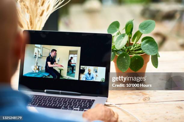physical therapist on laptop screen demonstrating treatment during videocall - mentoring virtual stock pictures, royalty-free photos & images