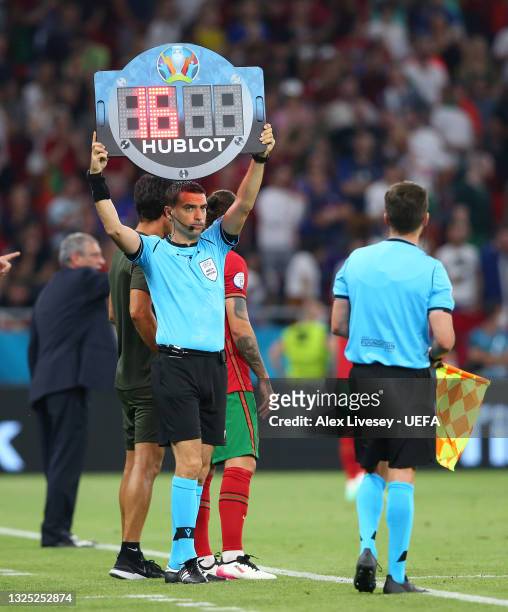 The assistant referee shows the substitute board during the UEFA Euro 2020 Championship Group F match between Portugal and France at Puskas Arena on...
