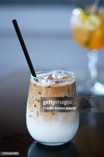 close-up of iced latte coffee and iced tea in glass on table . - カフェラテ ストックフォトと画像