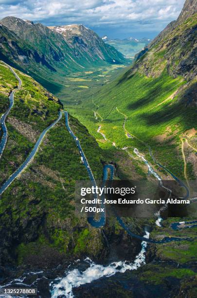 scenic view of green landscape against sky,trollstigen,norway - more og romsdal county stock pictures, royalty-free photos & images