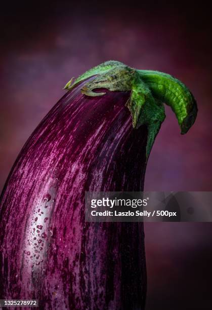 close-up of eggplants on table - aubergine stock-fotos und bilder