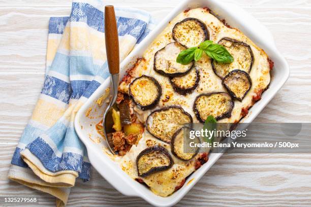 high angle view of food in plate on table - moussaka stockfoto's en -beelden