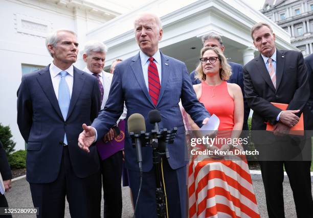 President Joe Biden , joined by from left to right, Sen. Rob Portman , Sen Bill Cassidy , Sen. Kyrsten Sinema and Sen. Mark Warner , speaks after the...