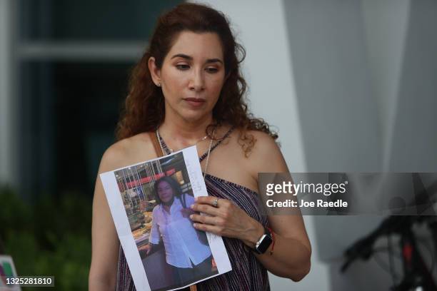 Luz Marina holds a picture of her aunt, Marina Azen, who she said is missing after the partial collapse of the 12-story Champlain Towers South condo...