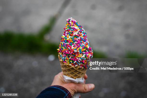 cropped hand holding ice cream cone,lansing,michigan,united states,usa - lansing stock pictures, royalty-free photos & images