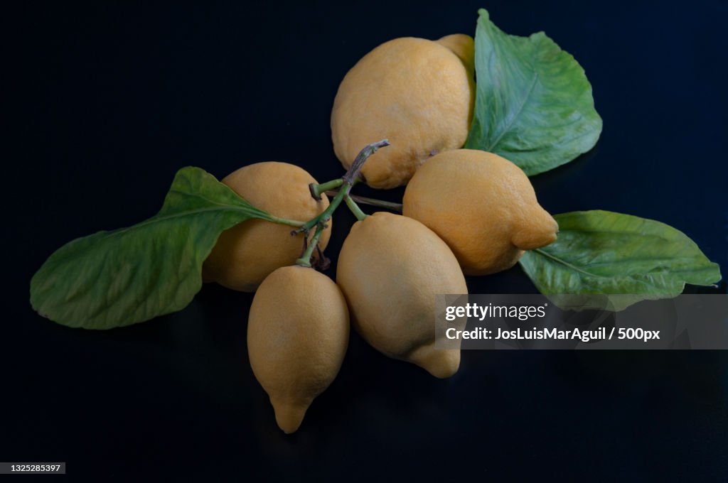 Close-up of fruits on table against black background