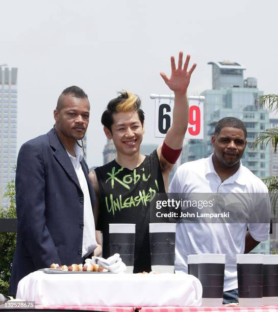 Brian Adams, Takeru Kobayashi and Tyrone Jackson attend Nathan's Famous Hot Dog Eating Contest via satellite at 230 Fifth Avenue on July 4, 2011 in...