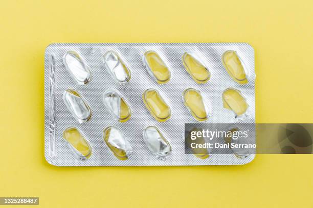 empty blister of tablets on a yellow background - blister pack stock-fotos und bilder