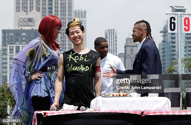 Mimi Imfurst, Takeru Kobayashi , Tyrone Jackson and Brian Adams attend Nathans Famous Hot Dog Eating Contest via satellite at 230 Fifth Avenue on...