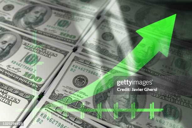 economy graph: green rising arrow and dollar bills. - dollar signs imagens e fotografias de stock