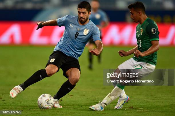Luis Suarez of Uruguay fights for the ball with Roberto Fernandez of Bolivia during a Group A match between Bolivia and Uruguay as part of Copa...