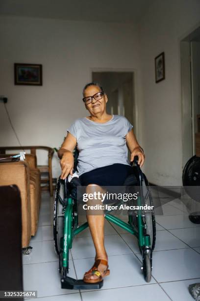woman in the wheelchair at home - diabetic amputation stock pictures, royalty-free photos & images
