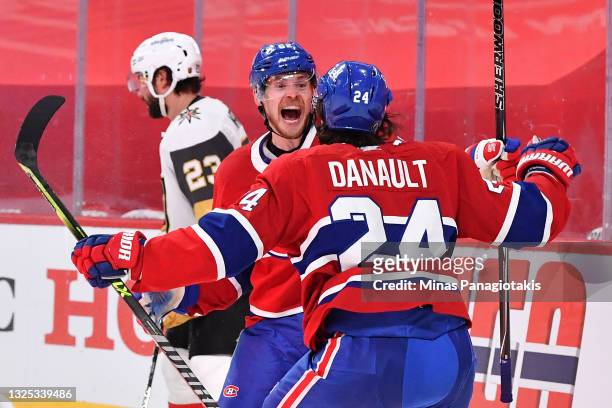 Artturi Lehkonen of the Montreal Canadiens is congratulated by Phillip Danault after scoring the game-winning goal during the first overtime period...