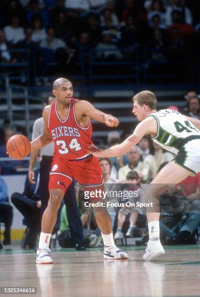 Charles Barkley of the Philadelphia 76ers looks to pass the ball by Paul Mokeski of the Milwaukee Bucks during an NBA basketball game circa 1987 at...