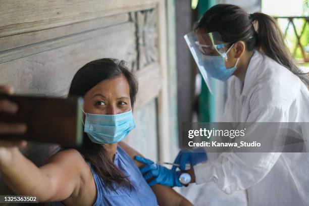 vietnamese woman taking a selfie before vaccination - global health stock pictures, royalty-free photos & images