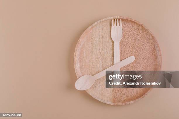 16:8 fasting diet concept. wooden plate and spoon, fork. copy space, top view - kazakhstan food stock pictures, royalty-free photos & images