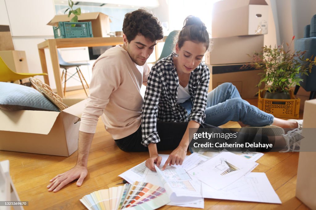 A young couple looking at plans of their new home