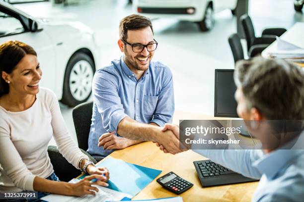 successful deal in a car showroom! - salesman gesturing stock pictures, royalty-free photos & images