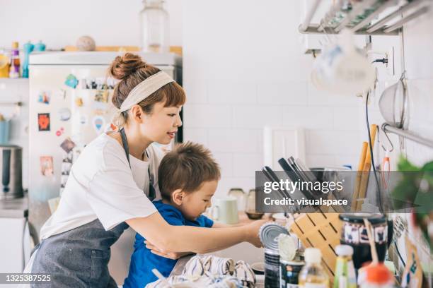 mother and son washing hands in kitchen - stay at home mother stockfoto's en -beelden
