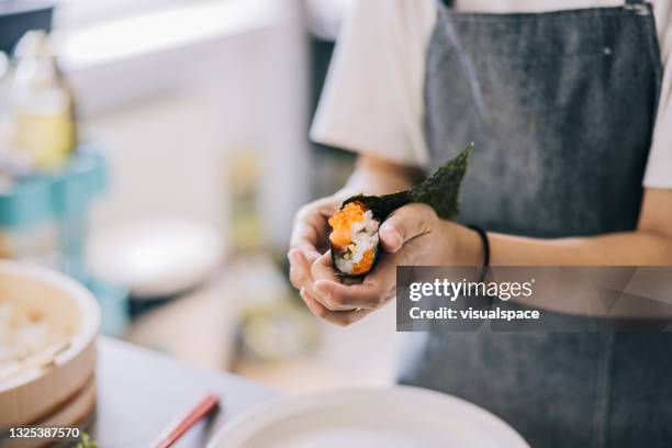 hand rolling temaki sushi - hand roll stock pictures, royalty-free photos & images