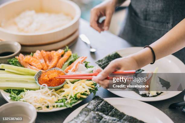 making temaki sushi at home - japanese food stock pictures, royalty-free photos & images