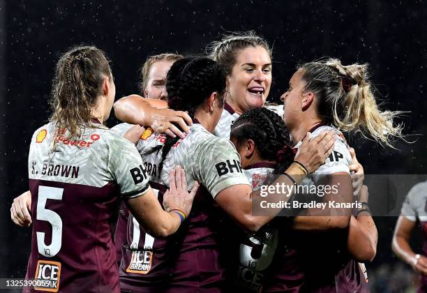 Destiny Brill of Queensland is congratulated by team mates after scoring a try during the Women's Rugby League State of Origin match at the Sunshine...