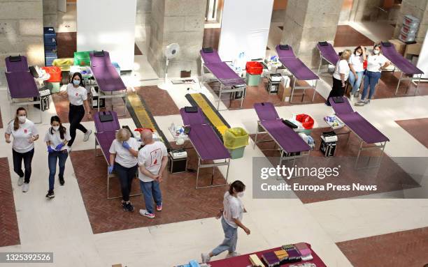 Group of volunteers in the device put in place at the headquarters of the regional government, the Real Casa de Correos, on June 25 in Madrid, . The...