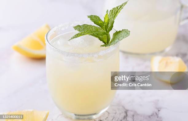 glass of homemade lemonade on marble surface - lemon juice bildbanksfoton och bilder