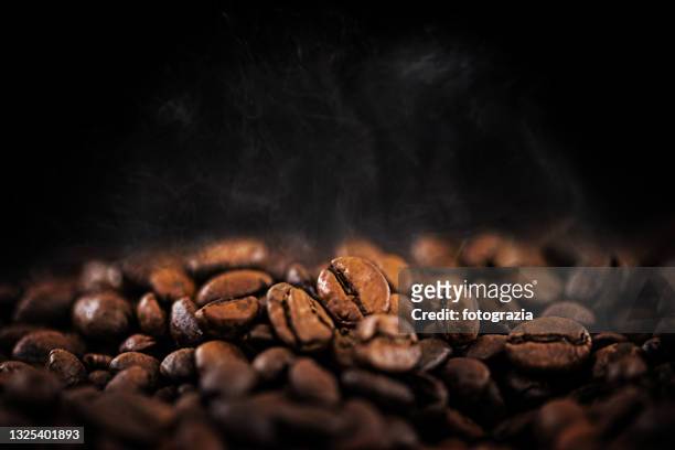 hot coffee beans with soft water vapor - roasted coffee bean stock pictures, royalty-free photos & images