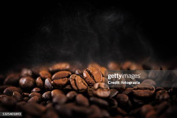 hot coffee beans with soft water vapor - coffee bean bildbanksfoton och bilder