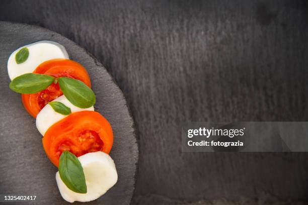 mozzarella, basil and tomatoes - caprese salad overhead stock pictures, royalty-free photos & images