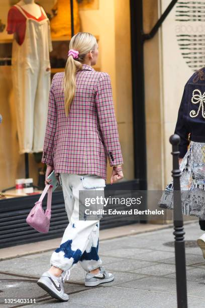 Guest wears a pink and gray checkered long blazer jacket, blue faded cargo denim jeans ripped pants with navy blue details on the ankle, gold / blue...